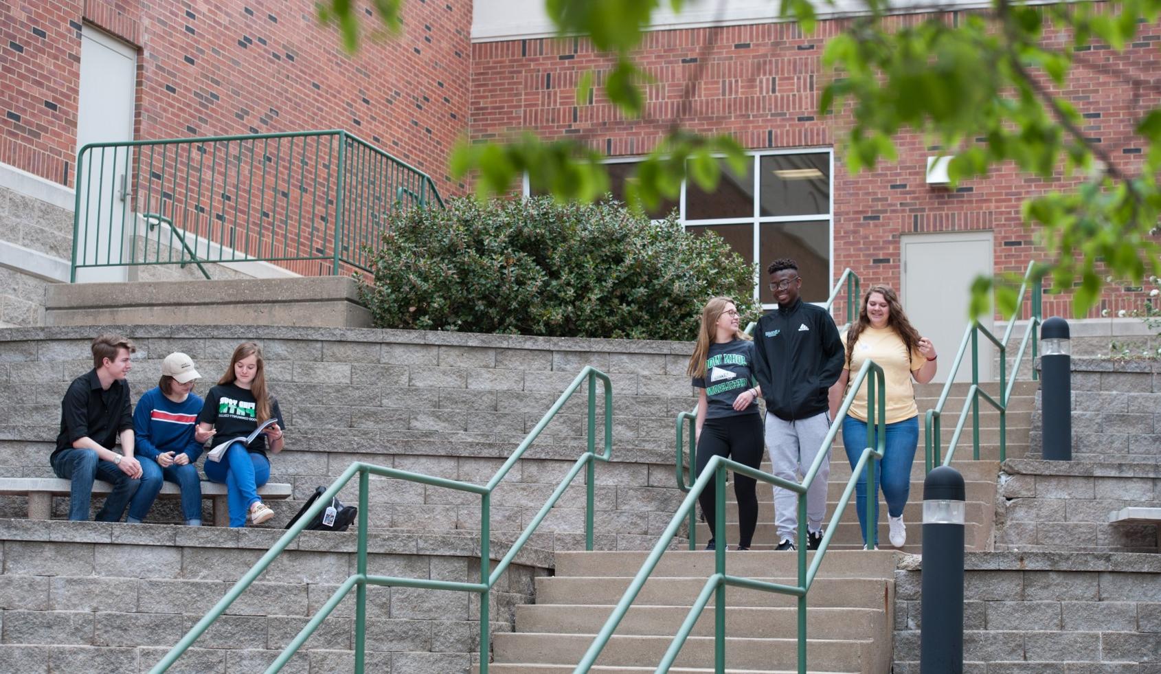 JWCC students walk down outside stairs on main campus
